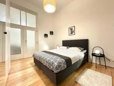a bedroom with a bed in a room with a window at Charming Uccle - 1 Bedroom APT Brussels in Brussels