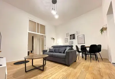 a living room with a couch and a table at Charming Uccle - 1 Bedroom APT Brussels in Brussels