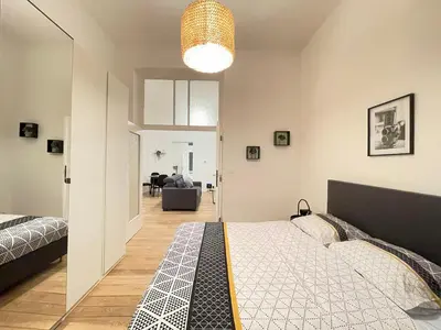 a bedroom with a bed and a living room at Charming Uccle - 1 Bedroom APT Brussels in Brussels