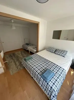 a bedroom with two beds and a mirror at Résidence 