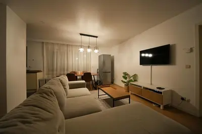 a living room with a couch and a tv at Cocon tout chaud - Pour couple avec ou sans bébé au rez-de-chaussée in Brussels