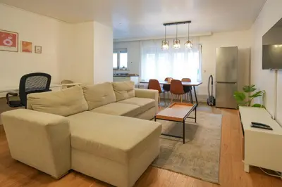 a living room with a couch and a table at Cocon tout chaud - Pour couple avec ou sans bébé au rez-de-chaussée in Brussels