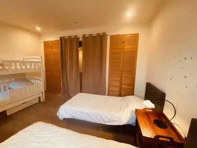 a bedroom with two beds and a desk with a night stand at Spacious duplex with terrace in the middle of the center in Ghent
