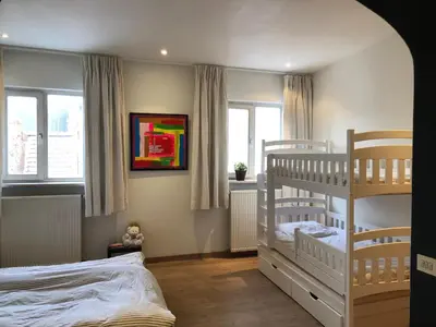 a bedroom with two bunk beds and a bed at Spacious duplex with terrace in the middle of the center in Ghent