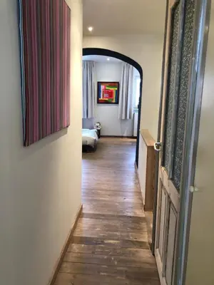 a hallway leading to a room with a bed at Spacious duplex with terrace in the middle of the center in Ghent