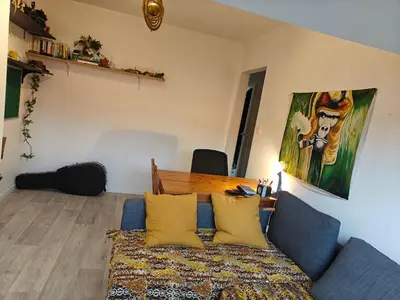 a living room with a couch and a table at Acacia Etterbeek in Brussels