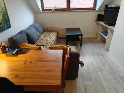a living room with a couch and a table at Acacia Etterbeek in Brussels