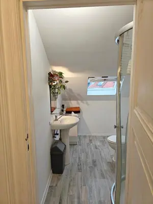 a small bathroom with a sink and a toilet at Acacia Etterbeek in Brussels