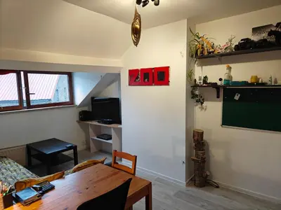a living room with a table and a chalkboard on the wall at Acacia Etterbeek in Brussels