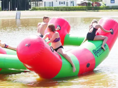 a group of people riding on inflatables in the water at Charming Breebos Getaway in Rijkevorsel