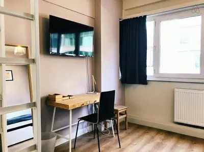 a room with a desk and a window and a desk at Fully equipped two bedroom apartment Schuman area in Brussels