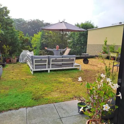 a man sitting on a bench under an umbrella at Carlotta Penthouse in Ghent