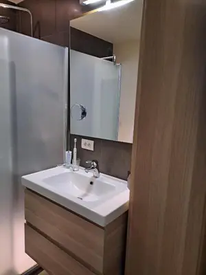 a bathroom with a white sink and a mirror at Carlotta Penthouse in Ghent