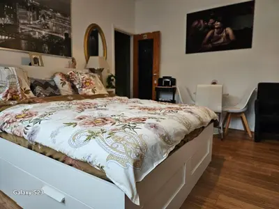 a bedroom with a bed and a desk with a chair at Friend House in Brussels