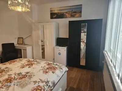 a bedroom with a bed and a mirror at Friend House in Brussels