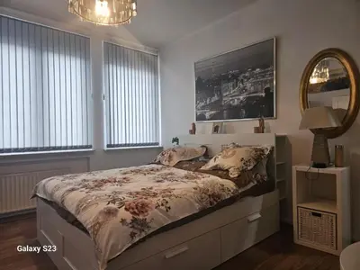 a bedroom with a bed and a mirror at Friend House in Brussels