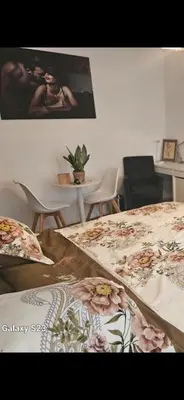 a room with a bed with a table and chairs at Friend House in Brussels