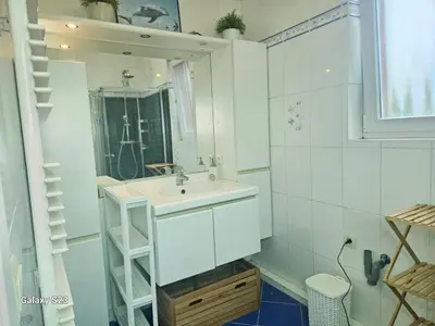 a bathroom with a sink and a mirror at Friend House in Brussels