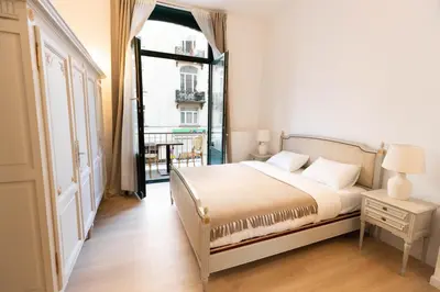 a bedroom with a bed and a large window at Gotha Aparthotel in Brussels