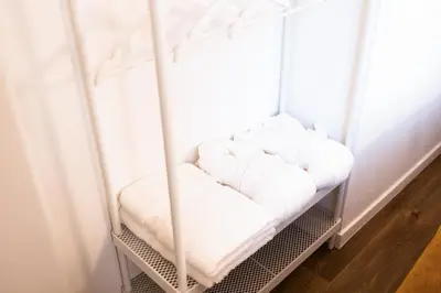 a room with a white seat in a room at Gotha Aparthotel in Brussels