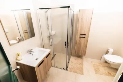 a bathroom with a shower and a sink and a toilet at Gotha Aparthotel in Brussels