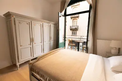 a bedroom with a large bed and a window at Gotha Aparthotel in Brussels