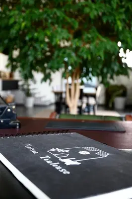 a sign on a table with trees in the background at Maison Toulouse in Affligem