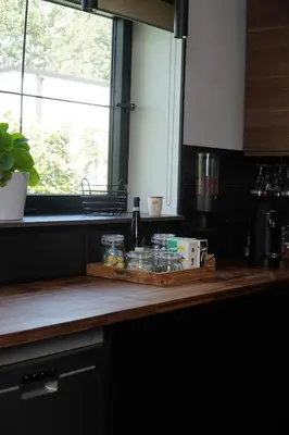 a kitchen counter with a cutting board and a window at Maison Toulouse in Affligem