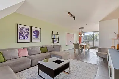 a living room with a couch and a table at Ruim 3 slaapkamer appartement met parking nabij NATO in Machelen