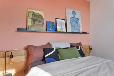 a bedroom with a bed and some pictures on the wall at Ruim 3 slaapkamer appartement met parking nabij NATO in Machelen