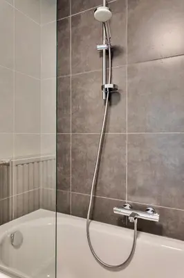 a bathroom with a shower with a bath tub at Ruim 3 slaapkamer appartement met parking nabij NATO in Machelen