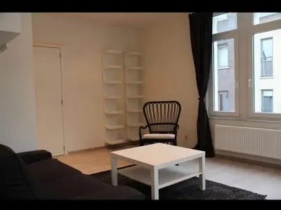 a living room with a couch and a table and a chair at Voskenslaan in Ghent