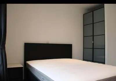 a bedroom with a bed with a black headboard at Voskenslaan in Ghent