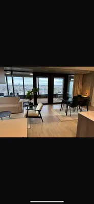 a living room with a couch and a table at Beautiful Apartment with Panoramic View of center with roof terrace in Brussels