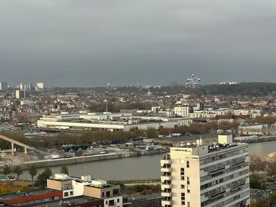 a view of a city with a river and buildings at Beautiful Apartment with Panoramic View of center with roof terrace in Brussels