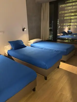 two beds in a room with a view of a city at Beautiful Apartment with Panoramic View of center with roof terrace in Brussels