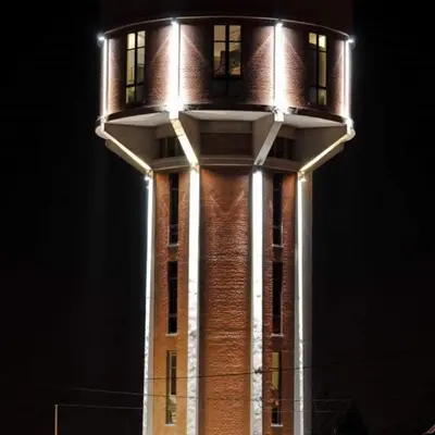 a tall tower with lights on top of it at Watertoren - Chateau d'Eau in Steenokkerzeel