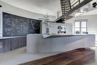 a kitchen with a counter with a chalkboard on the wall at Watertoren - Chateau d'Eau in Steenokkerzeel