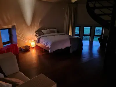 a bedroom with a bed with a light on it at Watertoren - Chateau d'Eau in Steenokkerzeel