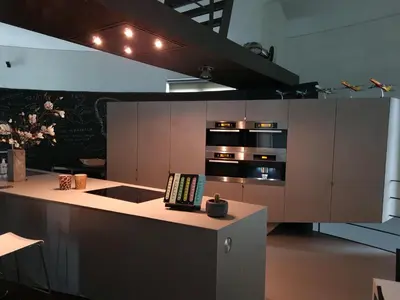 a kitchen with brown cabinets and a stove top oven at Watertoren - Chateau d'Eau in Steenokkerzeel