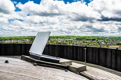 a monument on top of a building with a city at Watertoren - Chateau d'Eau in Steenokkerzeel