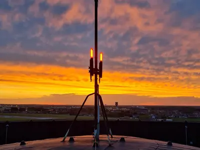 a candle holder on top of a roof with a sunset at Watertoren - Chateau d'Eau in Steenokkerzeel