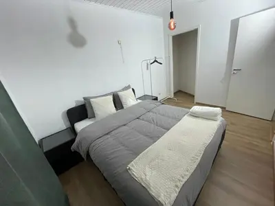 a bedroom with a large bed and a couch at Heart of Antwerpen in Antwerp