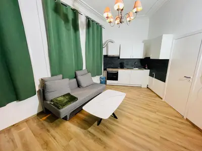 a living room with a couch and a kitchen at Heart of Antwerpen in Antwerp