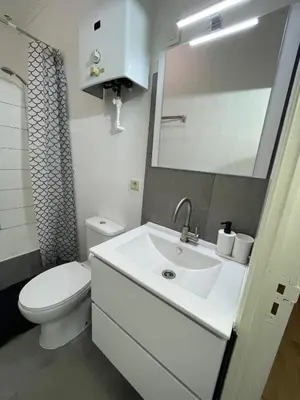 a bathroom with a white sink and a toilet at Heart of Antwerpen in Antwerp