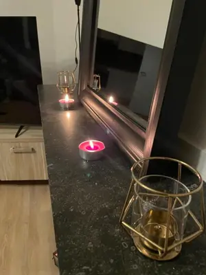 a counter with two candles and a glass bowl on it at Heart of Antwerpen in Antwerp
