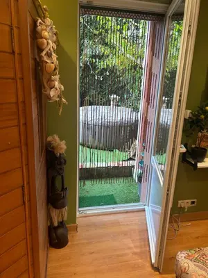 an open door to a patio with a gate at Tropical Room in Brussels