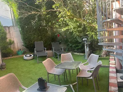 a group of chairs and tables in a garden at Tropical Room in Brussels