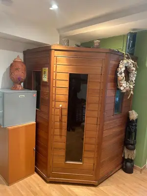 a large wooden cabinet in a room with a refrigerator at Tropical Room in Brussels