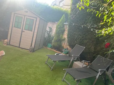 a yard with two chairs and a small shed at Tropical Room in Brussels